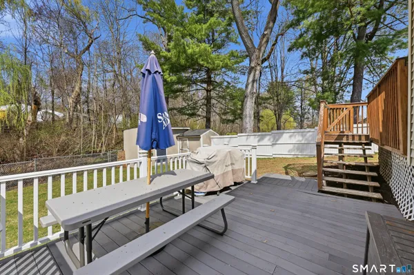 a view of a deck with two chair and wooden floor