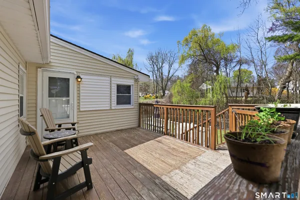 a view of a deck with wooden floor and seating space