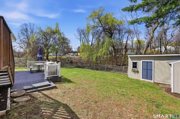 a view of a house with backyard and sitting area