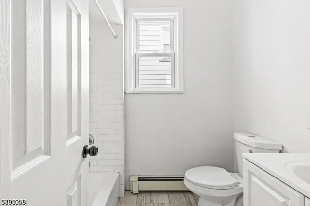 a bathroom with a toilet and a shower curtain