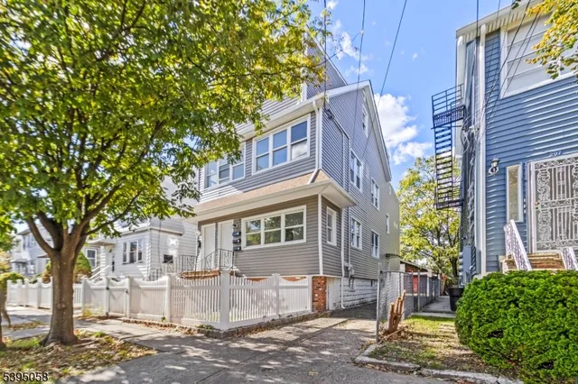 a view of a front of a house with a tree