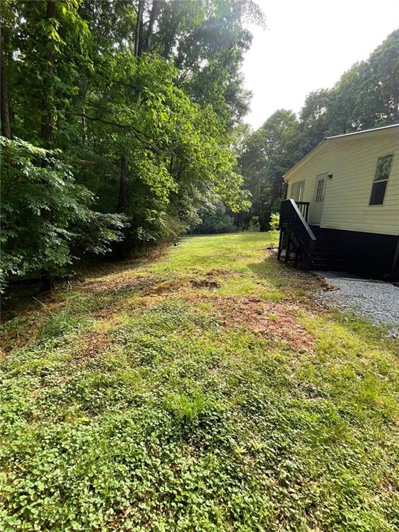 906 Jefferson River Road Jefferson, GA 30549 - Photo 20 of 25 a view of a backyard with plants and large trees