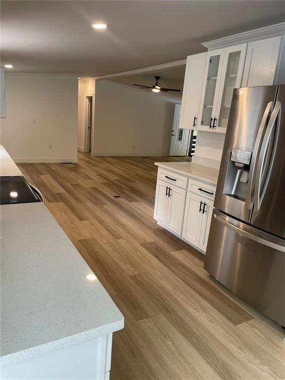 906 Jefferson River Road Jefferson, GA 30549 - Photo 6 of 25 a kitchen with a refrigerator and white cabinets