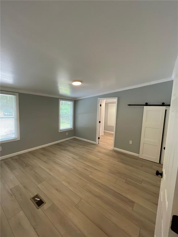 906 Jefferson River Road Jefferson, GA 30549 - Photo 8 of 25 an empty room with window and wooden floor