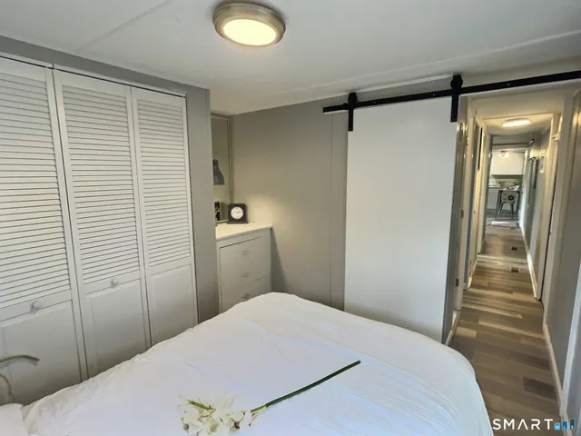a bedroom with a bed and a shower