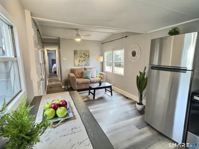 a living room with furniture and a wooden floor