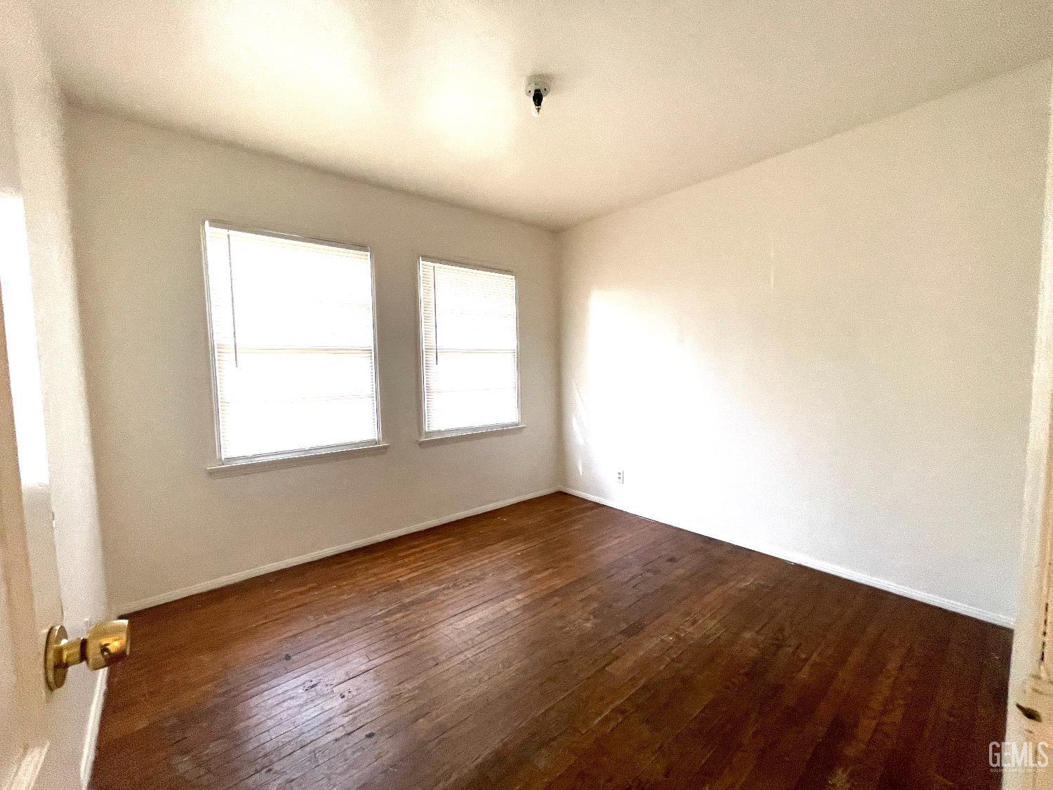 Undisclosed Address Bakersfield, CA 93304 - Photo 17 of 17 an empty room with wooden floor and windows