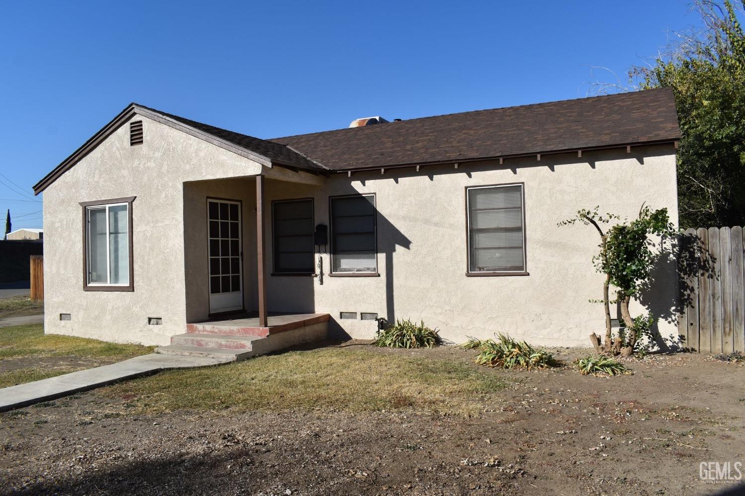Undisclosed Address Bakersfield, CA 93304 - Photo 2 of 17 a front view of a house with a yard