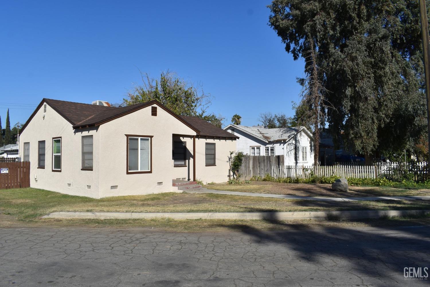 Undisclosed Address Bakersfield, CA 93304 - Photo 4 of 17 a view of white house with a yard