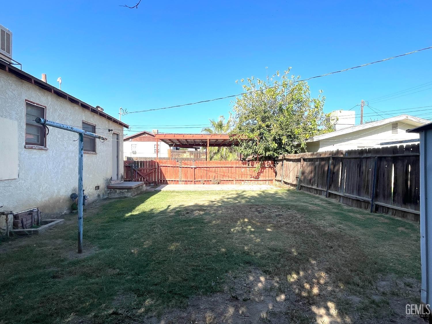 Undisclosed Address Bakersfield, CA 93304 - Photo 10 of 17 a backyard of a house with lots of green space
