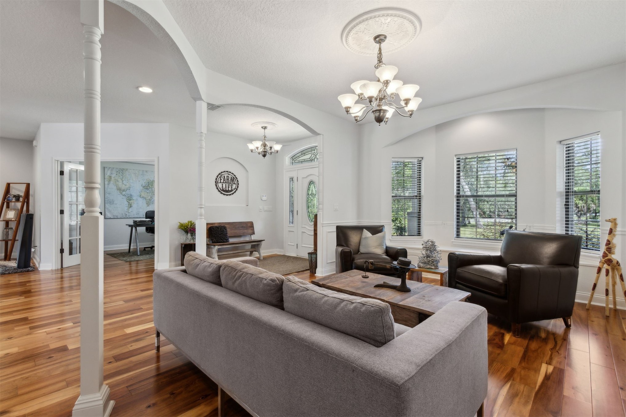 87377 Raddin Road Yulee, FL 32097 - Photo 21 of 75 a living room with fireplace furniture and a chandelier