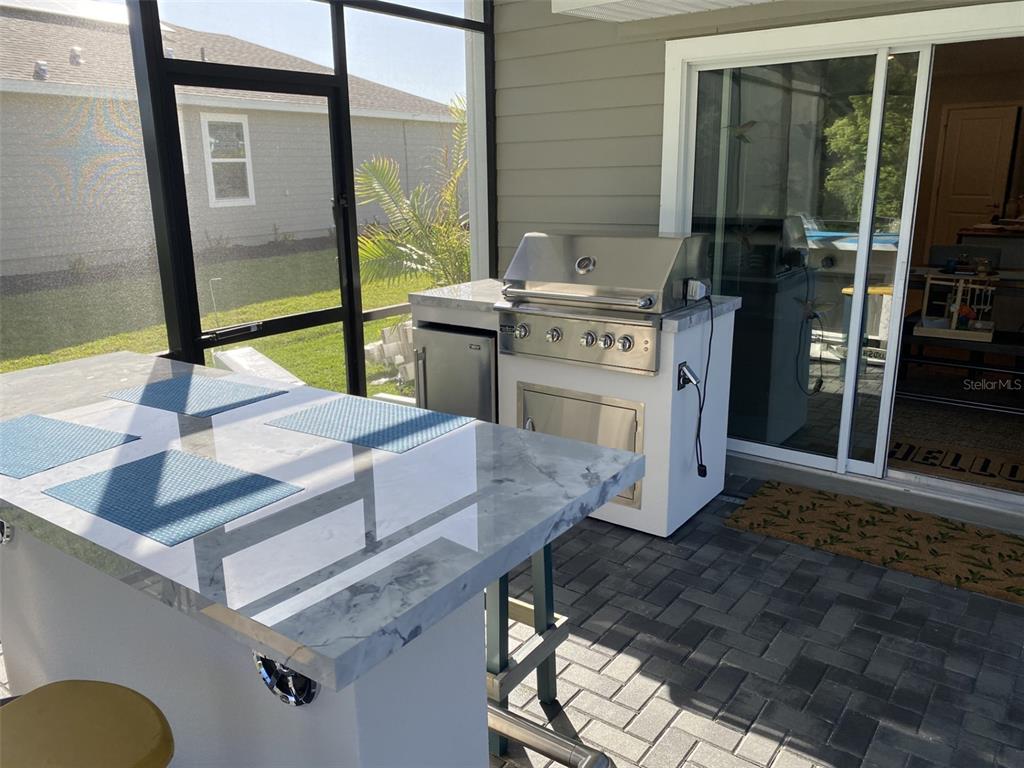 5686 Alenlon Way Mount Dora, FL 32757 - Photo 20 of 62 a kitchen with stainless steel appliances granite countertop a sink stove and cabinets
