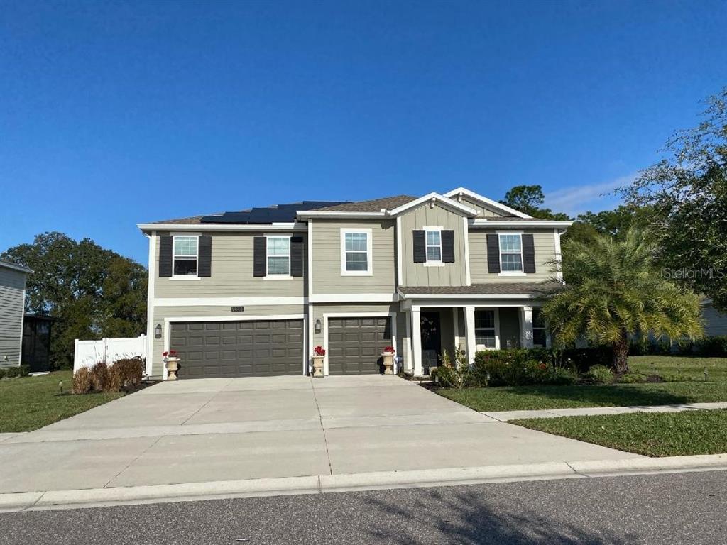 5686 Alenlon Way Mount Dora, FL 32757 - Photo 3 of 62 a front view of a house with a yard and garage