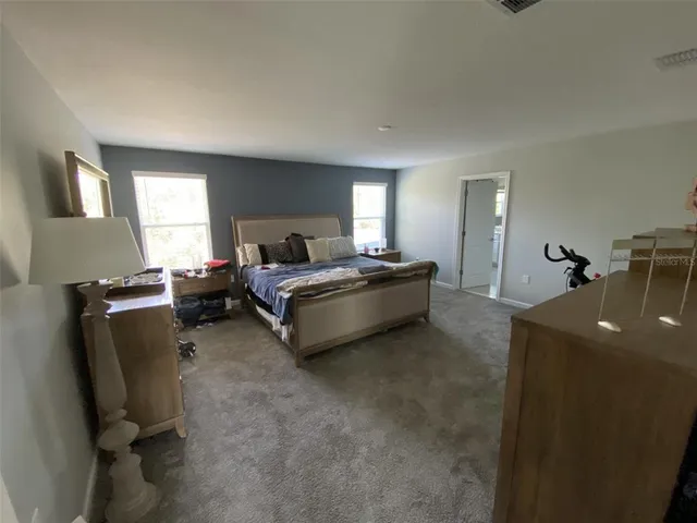 a en suite bathroom with a double vanity sink and a mirror