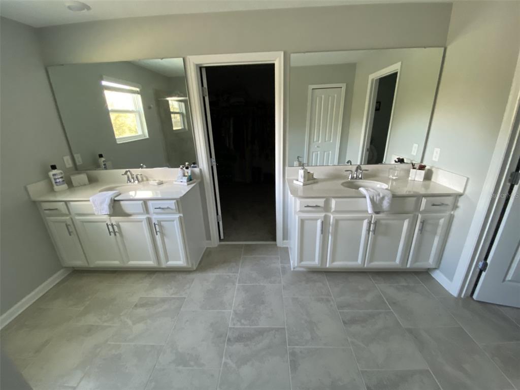 5686 Alenlon Way Mount Dora, FL 32757 - Photo 31 of 62 a utility room with cabinets and washer