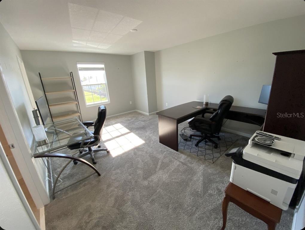 5686 Alenlon Way Mount Dora, FL 32757 - Photo 32 of 62 a view of a workspace with furniture and a window