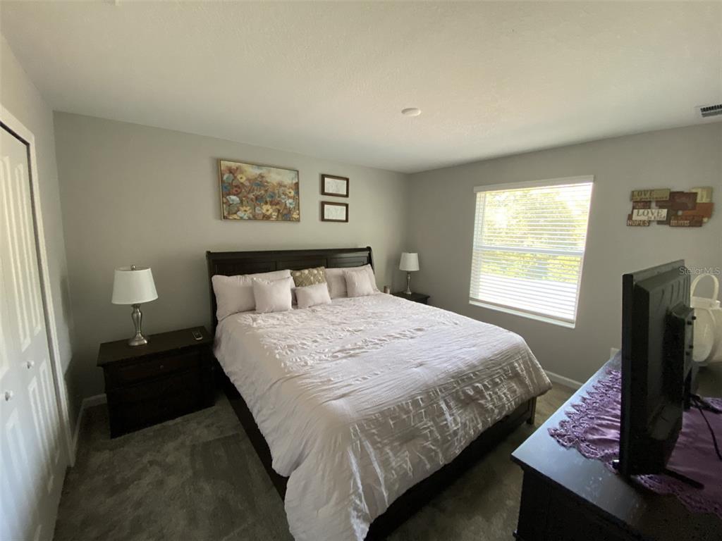 5686 Alenlon Way Mount Dora, FL 32757 - Photo 34 of 62 a bedroom with bed and window