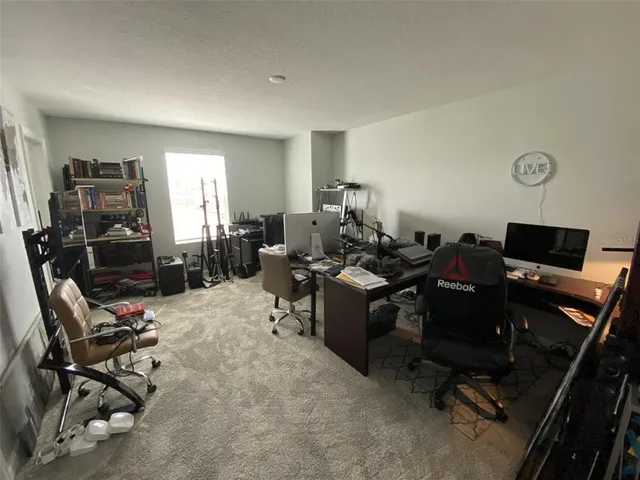 a view of a backyard with plants and patio