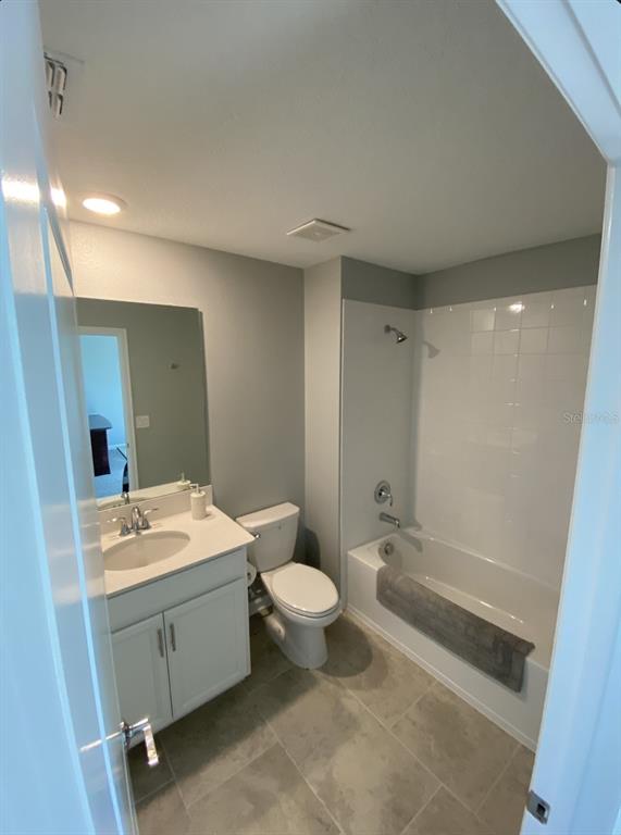 5686 Alenlon Way Mount Dora, FL 32757 - Photo 41 of 62 a bathroom with a sink a toilet a mirror and shower