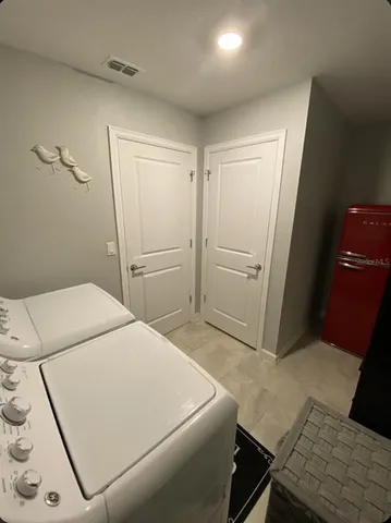 a view of a backyard with plants and patio