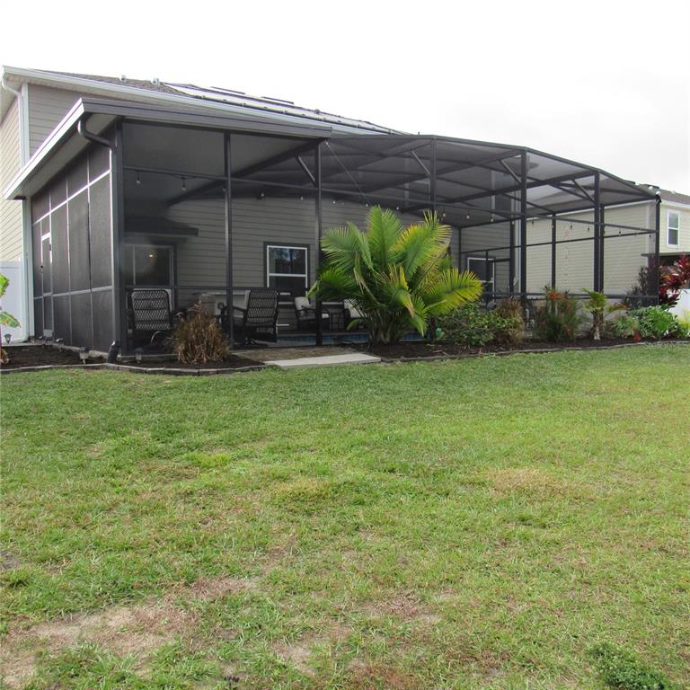 5686 Alenlon Way Mount Dora, FL 32757 - Photo 46 of 62 a view of a backyard with plants and patio