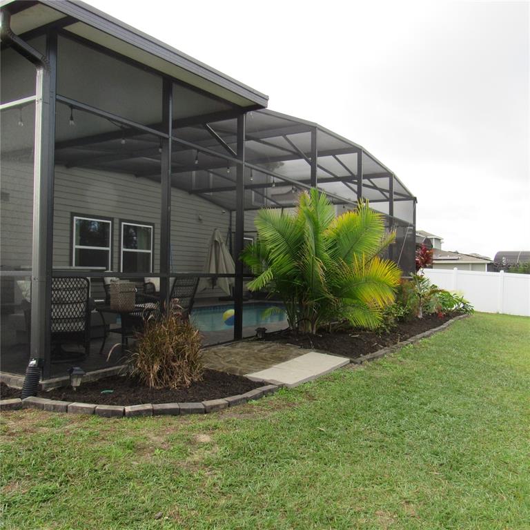 5686 Alenlon Way Mount Dora, FL 32757 - Photo 47 of 62 a view of a house with backyard and garden