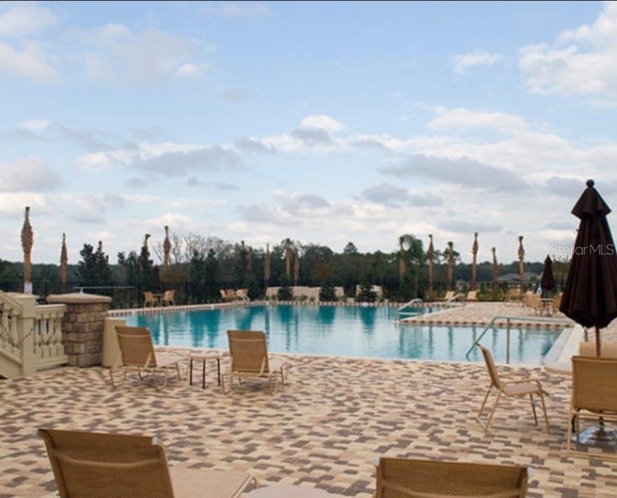 5686 Alenlon Way Mount Dora, FL 32757 - Photo 59 of 62 a view of a lake with a table and chairs