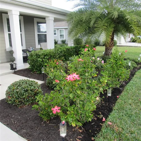 a dining room with furniture a flat screen tv and kitchen view