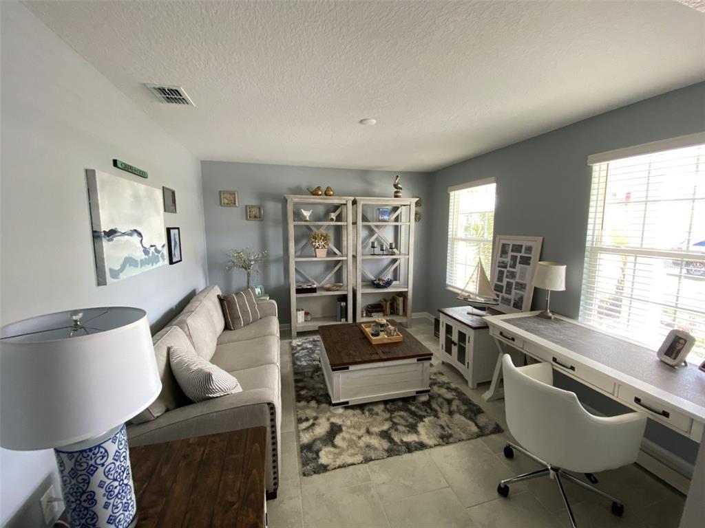 5686 Alenlon Way Mount Dora, FL 32757 - Photo 8 of 62 a living room with furniture and a large window