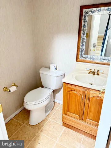 a bathroom with a toilet a sink and a mirror