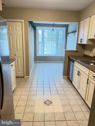 a kitchen with a sink a stove and a refrigerator