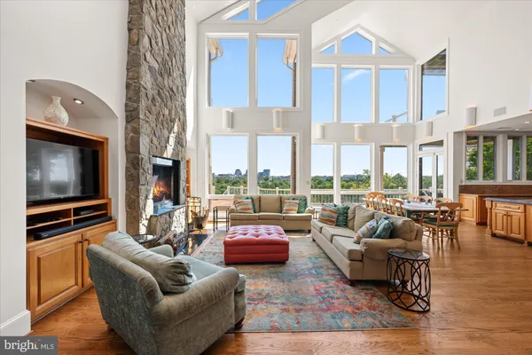 a kitchen with stainless steel appliances granite countertop a stove a sink dishwasher and a refrigerator with wooden cabinets