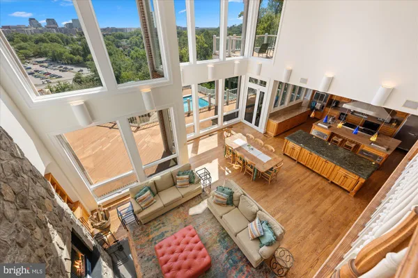 a living room with furniture a rug and a dining table