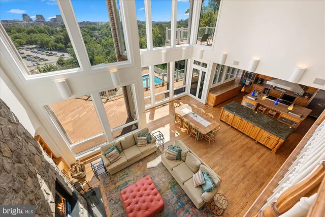 a living room with furniture a rug and a dining table