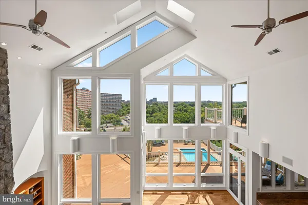 a view of a dining room and livingroom furniture wooden floor a rug and a chandelier