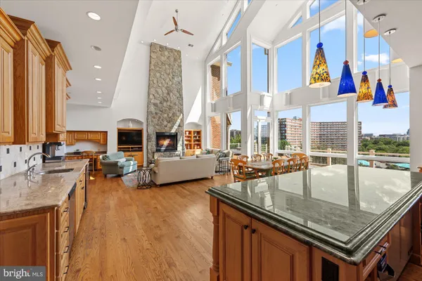 a roof deck with table and chairs a barbeque with wooden floor and fence