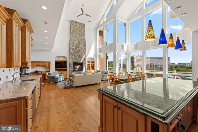 a roof deck with table and chairs a barbeque with wooden floor and fence