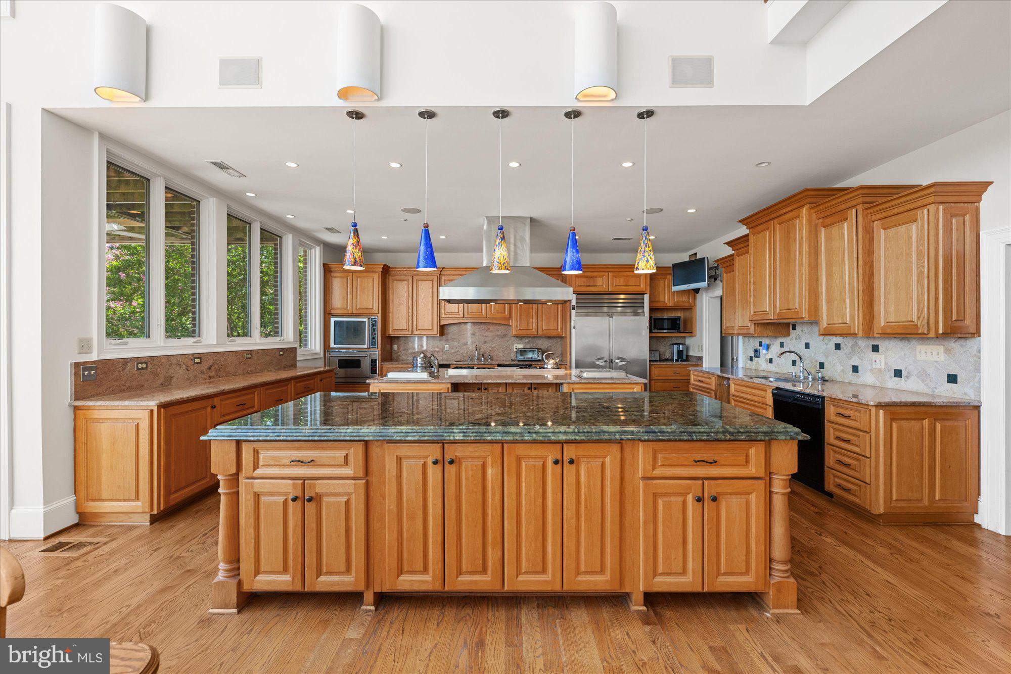 1701 South Arlington Ridge Road Arlington, VA 22202 - Photo 25 of 90 a kitchen with kitchen island granite countertop a sink and a stove