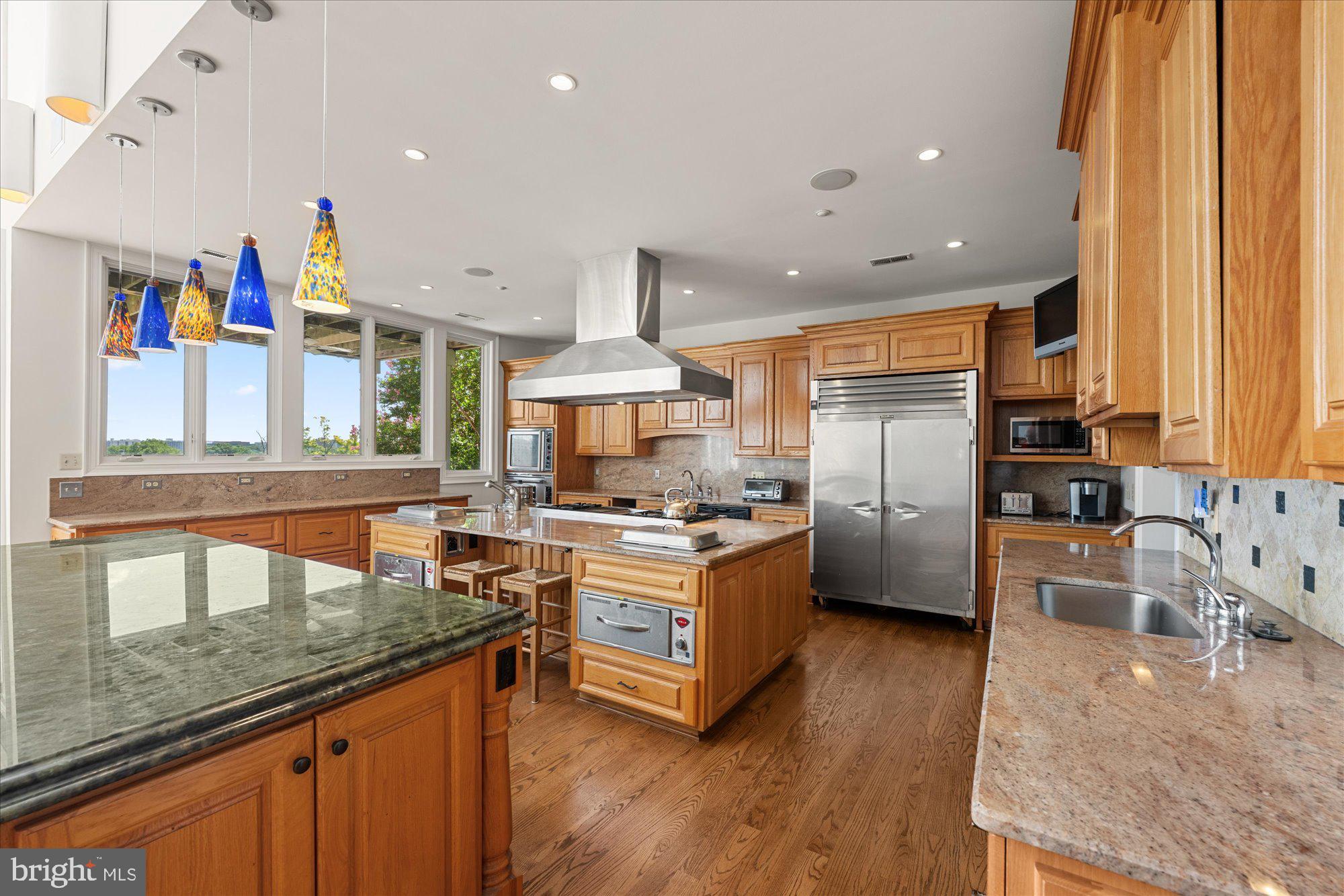 1701 South Arlington Ridge Road Arlington, VA 22202 - Photo 26 of 90 a kitchen with stainless steel appliances granite countertop a stove a sink and a refrigerator