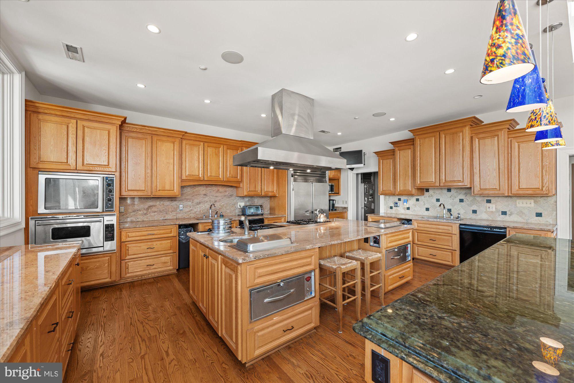 1701 South Arlington Ridge Road Arlington, VA 22202 - Photo 28 of 90 a kitchen with stainless steel appliances granite countertop a stove a sink dishwasher and a refrigerator with wooden cabinets