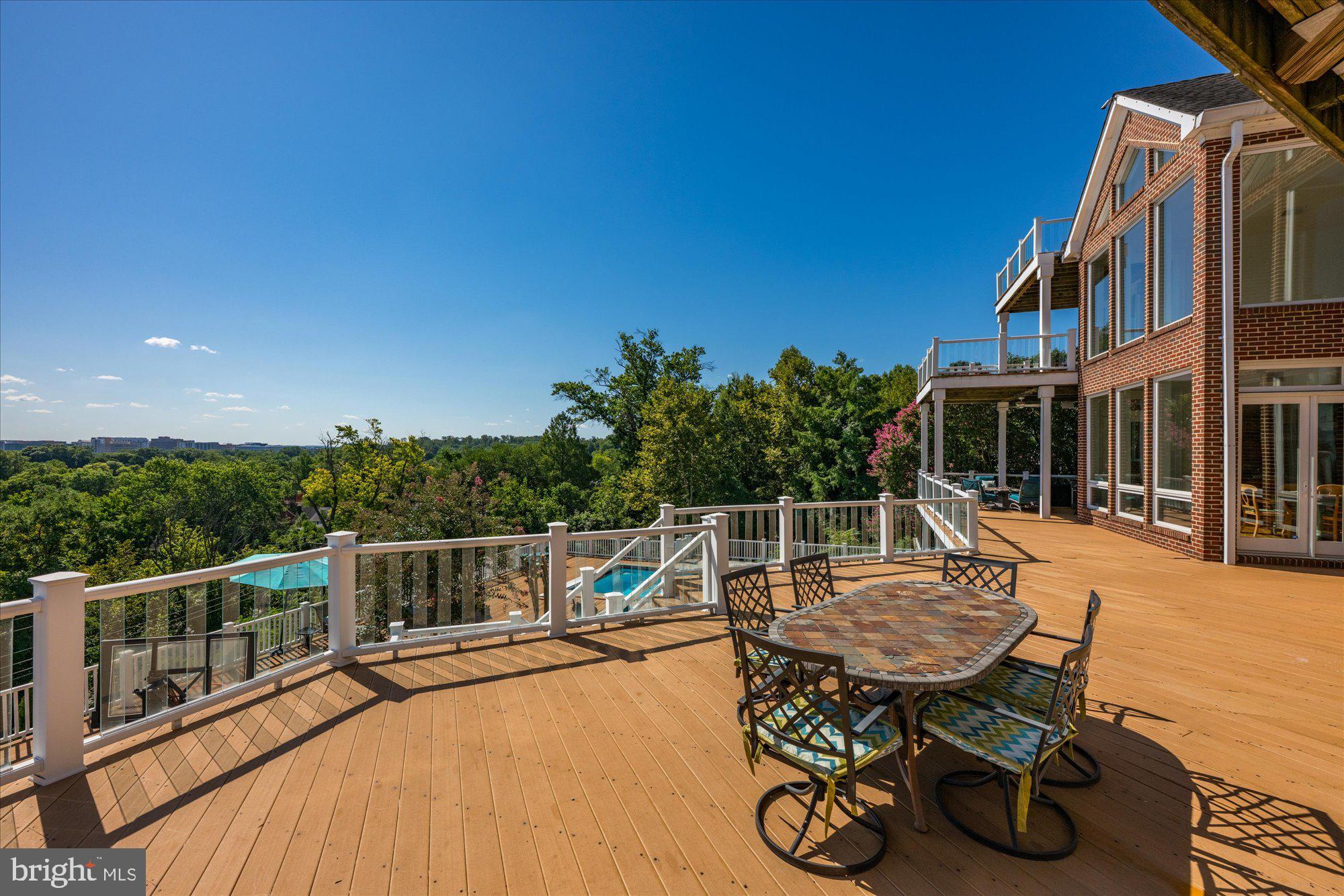 1701 South Arlington Ridge Road Arlington, VA 22202 - Photo 39 of 90 a roof deck with table and chairs a barbeque with wooden floor and fence