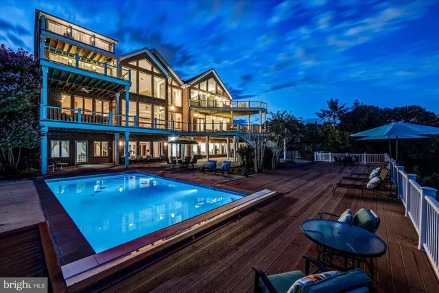 a living room with fireplace furniture and a large window