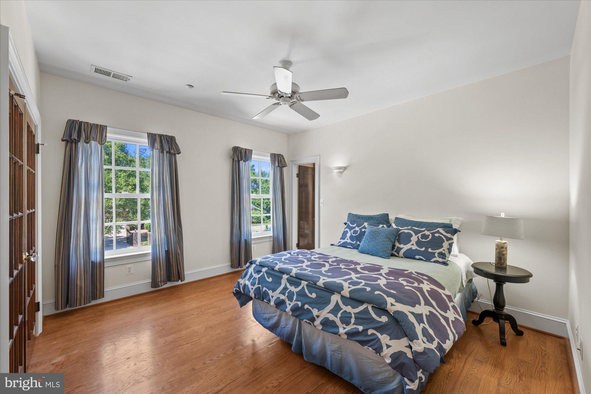 1701 South Arlington Ridge Road Arlington, VA 22202 - Photo 54 of 90 a bedroom with a large bed and a chandelier