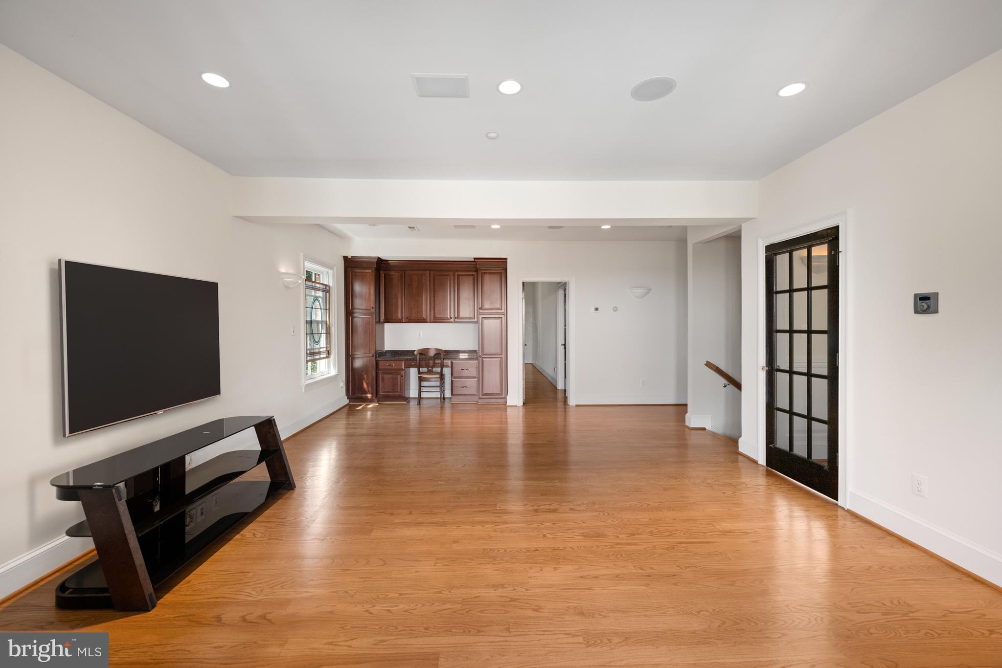 1701 South Arlington Ridge Road Arlington, VA 22202 - Photo 58 of 90 a view of a livingroom with furniture hardwood floor and a flat screen tv