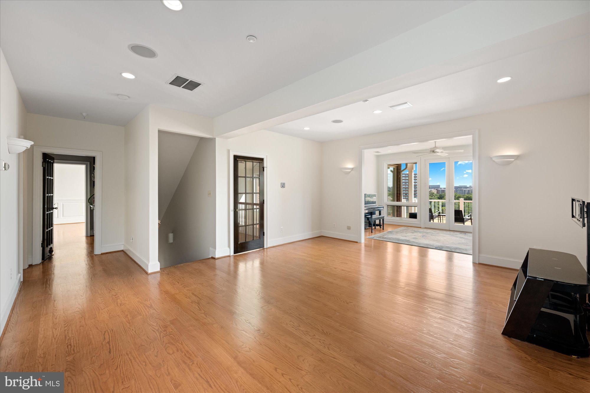 1701 South Arlington Ridge Road Arlington, VA 22202 - Photo 59 of 90 a view of a livingroom with wooden floor and a flat screen tv