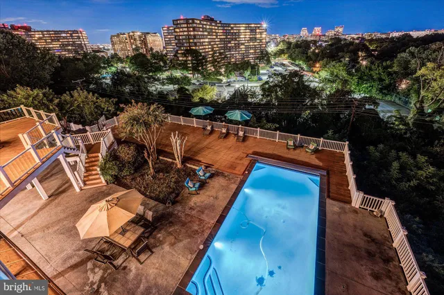 a kitchen with stainless steel appliances granite countertop a barbecue grill and a view of living room