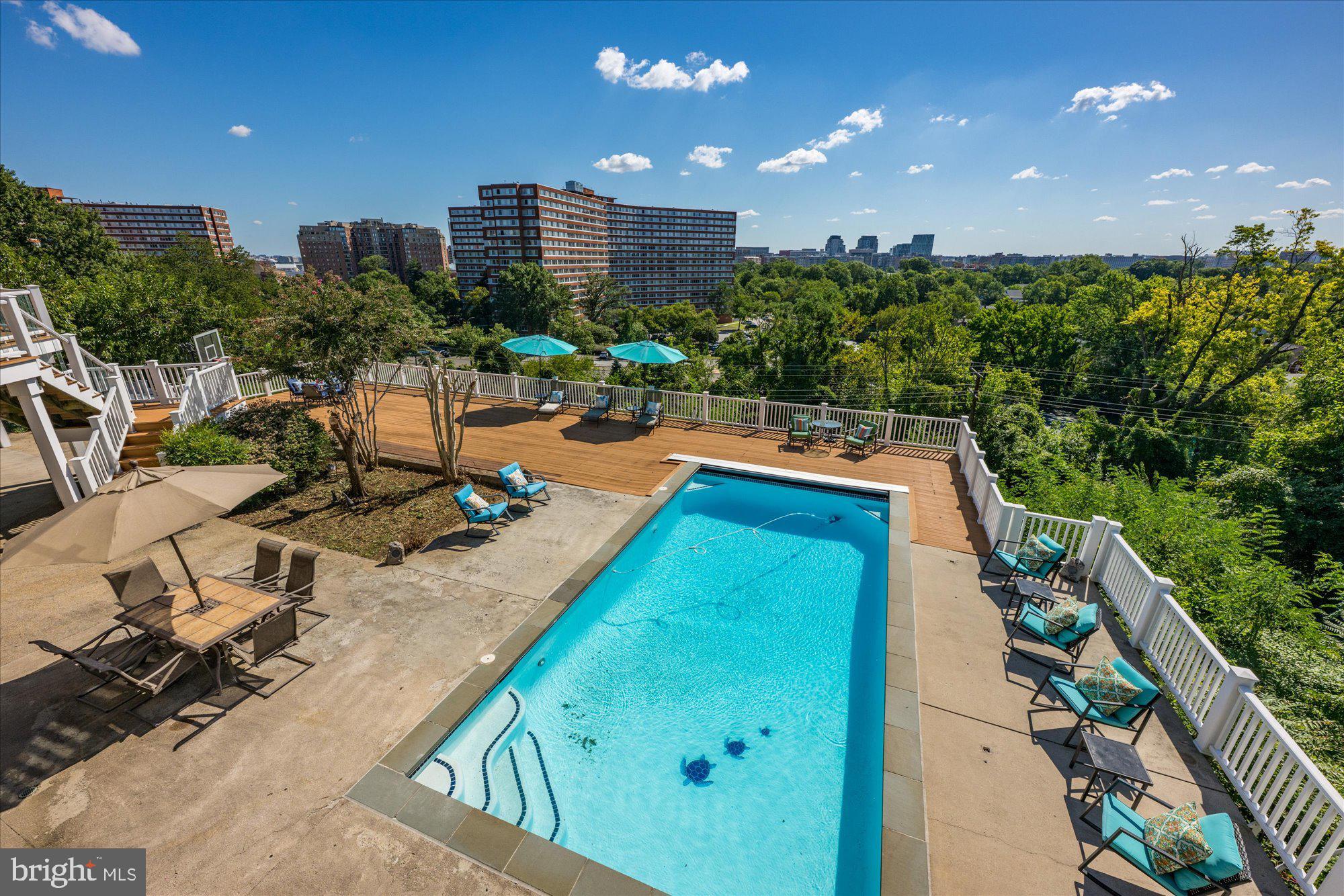 1701 South Arlington Ridge Road Arlington, VA 22202 - Photo 87 of 90 a view of a swimming pool with outdoor seating and plants