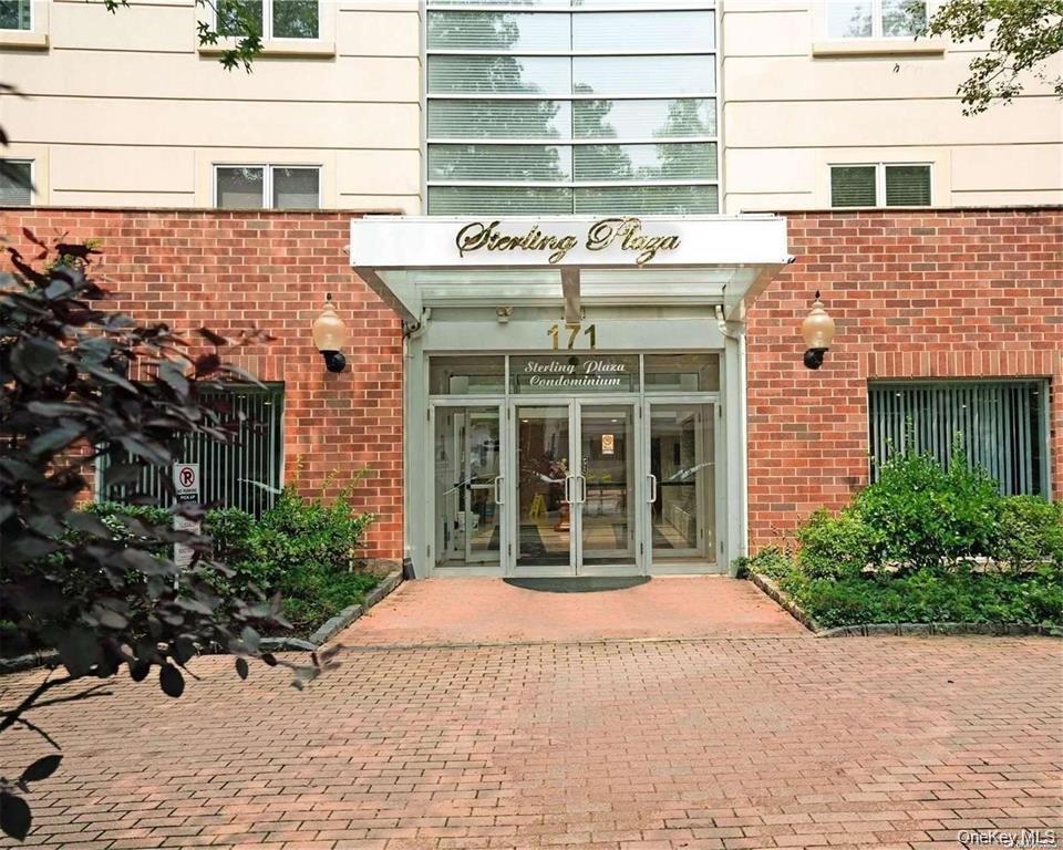 a view of a brick building with large windows