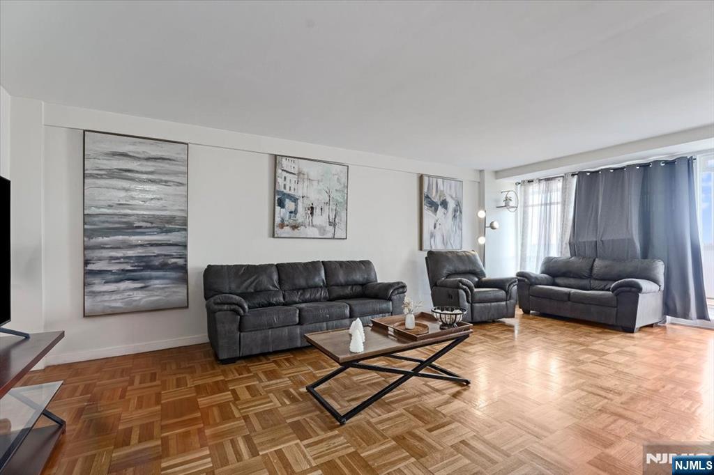 90 Prospect Avenue, Unit 7A Hackensack, NJ 07601 - Photo 2 of 21 a living room with furniture and a flat screen tv