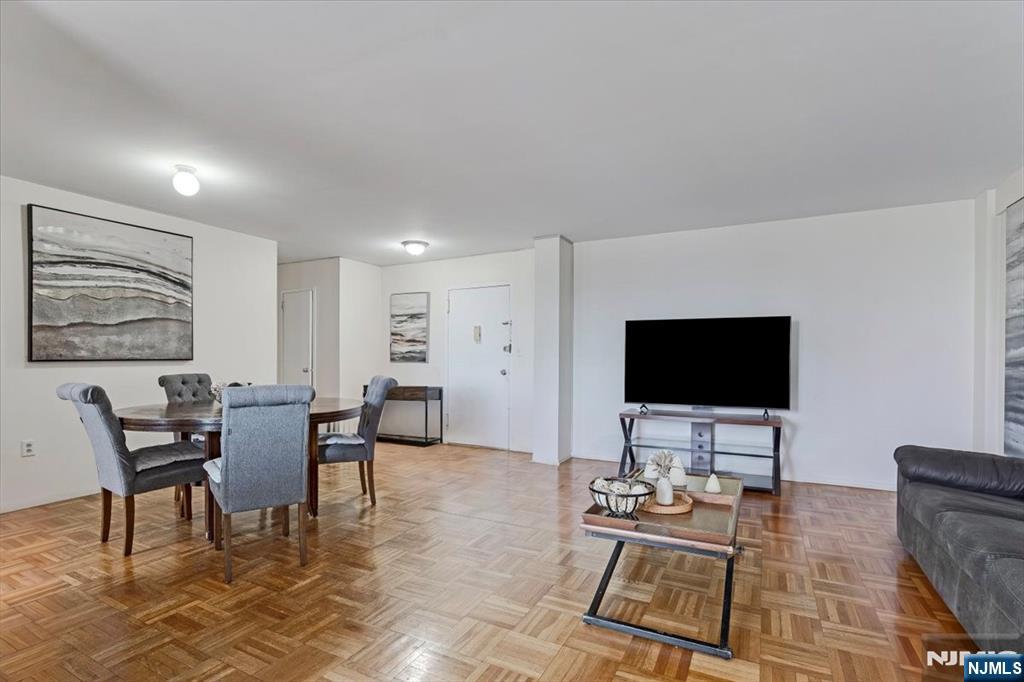 90 Prospect Avenue, Unit 7A Hackensack, NJ 07601 - Photo 3 of 21 a living room with furniture and a flat screen tv